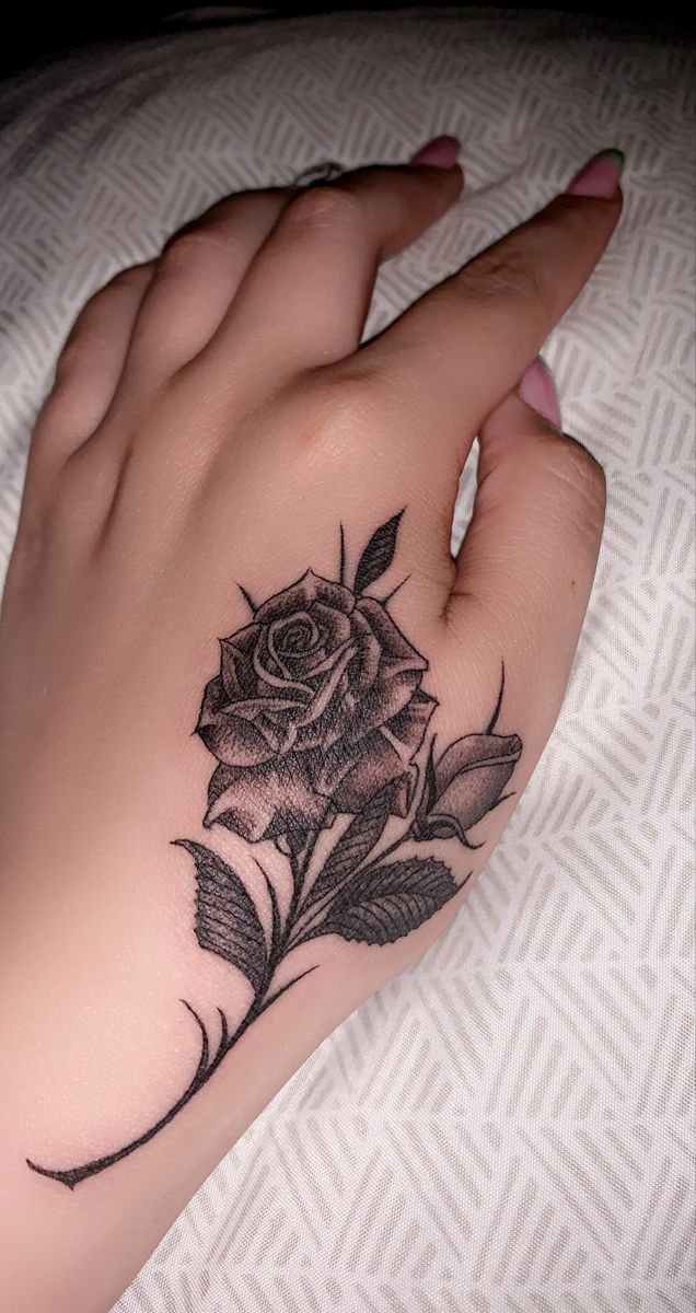 Rose hand tattoo ideas for women featuring black, red, and blue designs ...